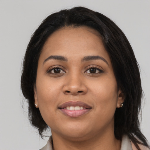 Joyful latino young-adult female with medium  black hair and brown eyes