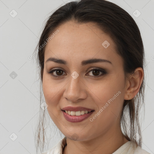 Joyful white young-adult female with long  brown hair and brown eyes