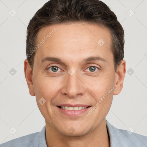 Joyful white adult male with short  brown hair and brown eyes