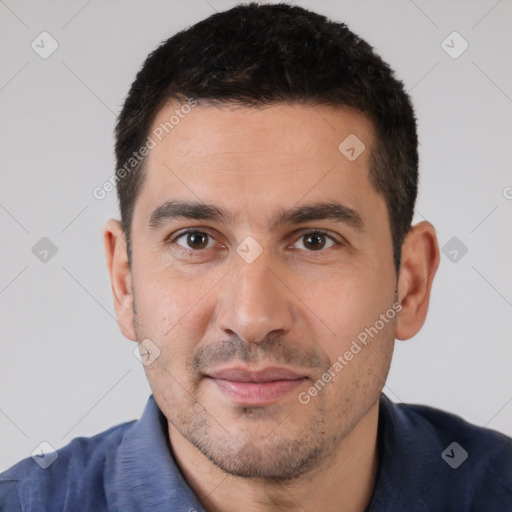 Joyful white young-adult male with short  black hair and brown eyes