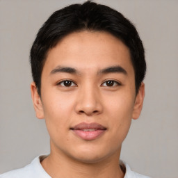 Joyful asian young-adult male with short  brown hair and brown eyes