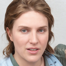 Joyful white young-adult female with medium  brown hair and blue eyes