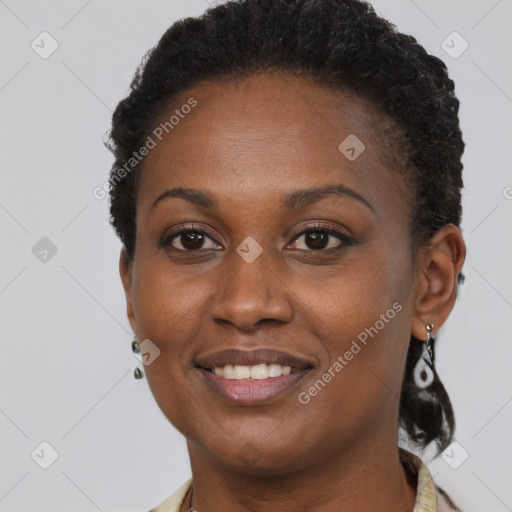 Joyful black young-adult female with short  brown hair and brown eyes