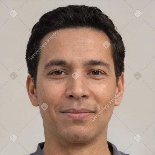 Joyful white adult male with short  black hair and brown eyes