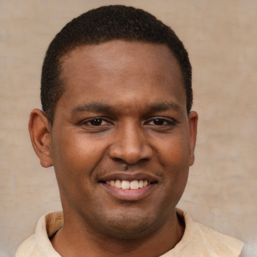 Joyful latino young-adult male with short  brown hair and brown eyes