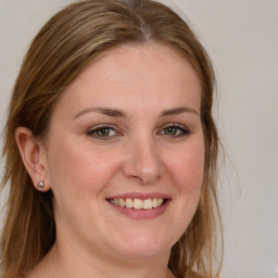 Joyful white young-adult female with long  brown hair and blue eyes