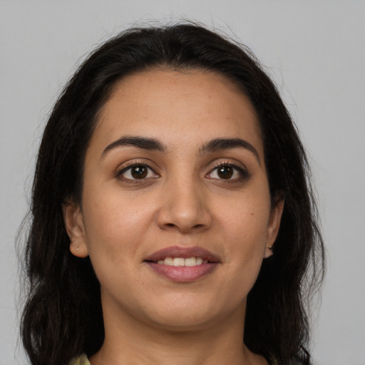 Joyful white young-adult female with long  brown hair and brown eyes