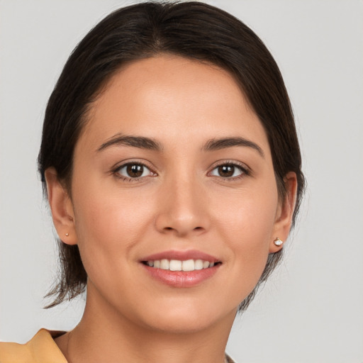 Joyful white young-adult female with medium  brown hair and brown eyes