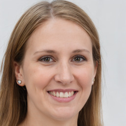 Joyful white young-adult female with long  brown hair and grey eyes