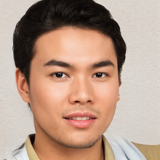 Joyful asian young-adult male with short  brown hair and brown eyes