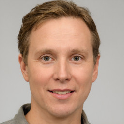 Joyful white adult male with short  brown hair and grey eyes