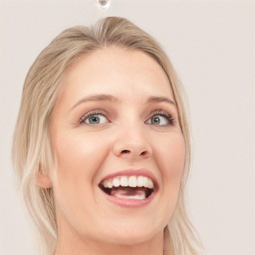 Joyful white young-adult female with medium  blond hair and blue eyes