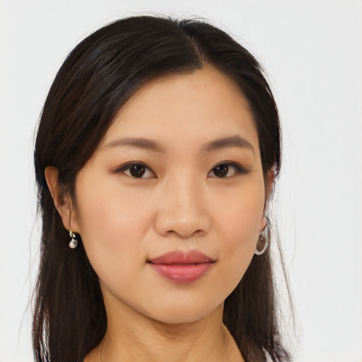 Joyful asian young-adult female with long  brown hair and brown eyes