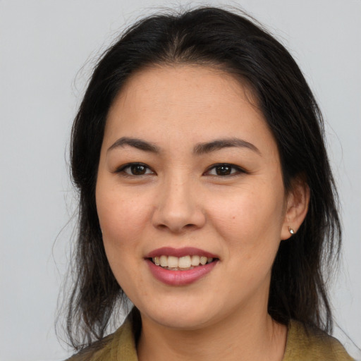 Joyful asian young-adult female with long  brown hair and brown eyes