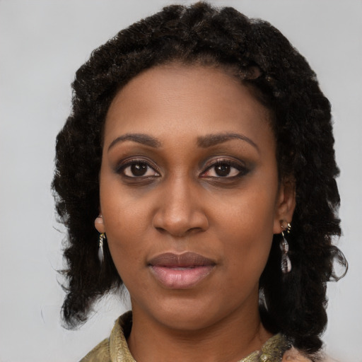 Joyful black young-adult female with medium  black hair and brown eyes