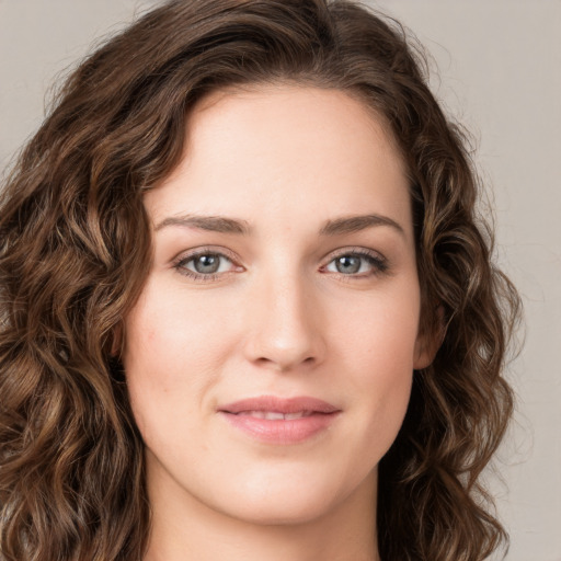 Joyful white young-adult female with long  brown hair and green eyes