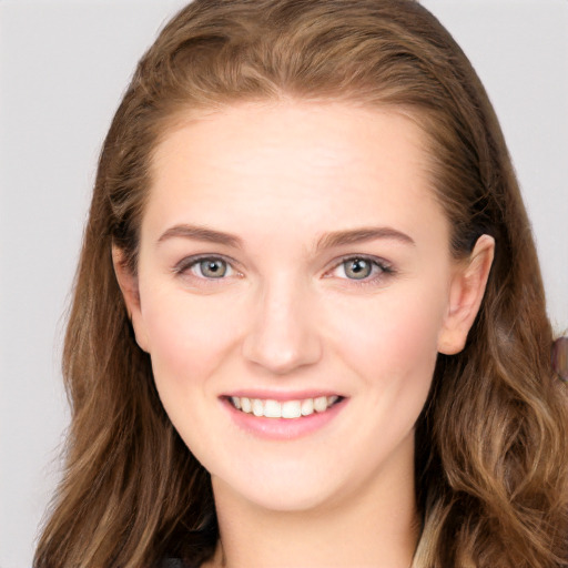 Joyful white young-adult female with long  brown hair and blue eyes