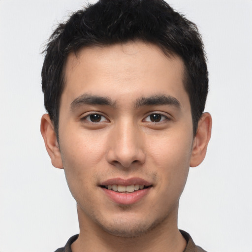 Joyful latino young-adult male with short  brown hair and brown eyes