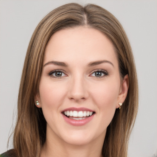 Joyful white young-adult female with long  brown hair and green eyes