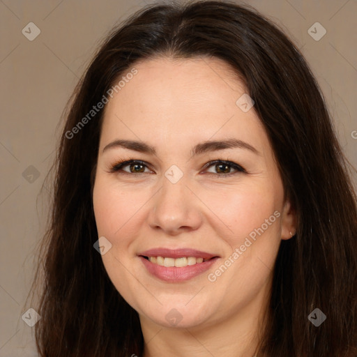 Joyful white adult female with long  brown hair and brown eyes