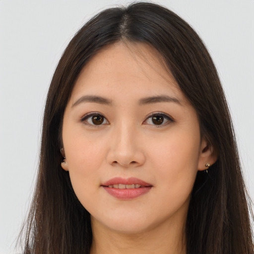 Joyful asian young-adult female with long  brown hair and brown eyes