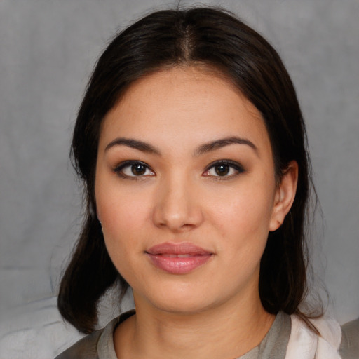 Joyful asian young-adult female with medium  brown hair and brown eyes