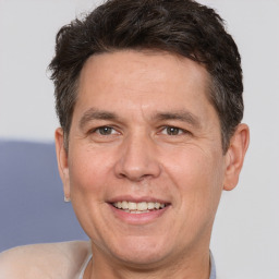 Joyful white adult male with short  brown hair and brown eyes