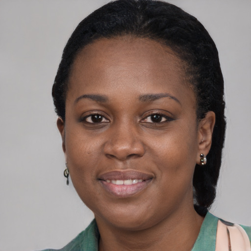 Joyful black young-adult female with short  black hair and brown eyes