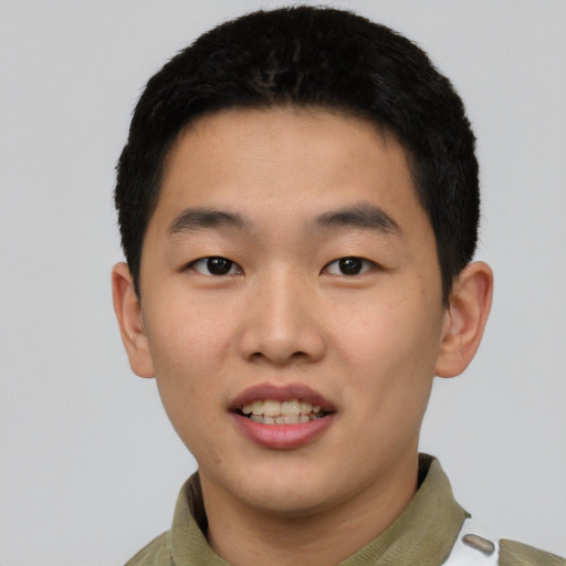 Joyful asian young-adult male with short  black hair and brown eyes