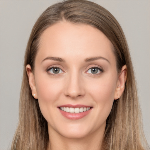 Joyful white young-adult female with long  brown hair and grey eyes