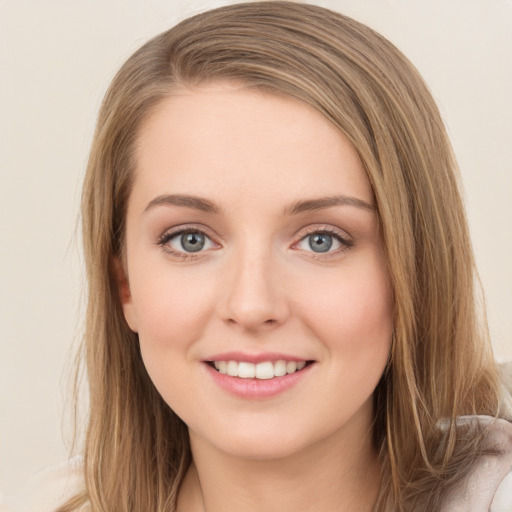 Joyful white young-adult female with long  brown hair and green eyes