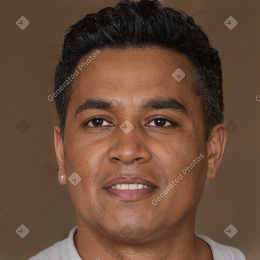 Joyful latino adult male with short  brown hair and brown eyes