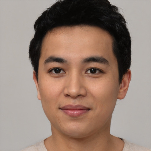 Joyful asian young-adult male with short  black hair and brown eyes