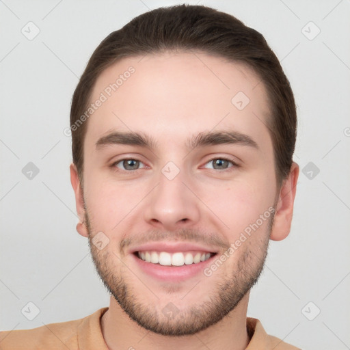 Joyful white young-adult male with short  brown hair and grey eyes