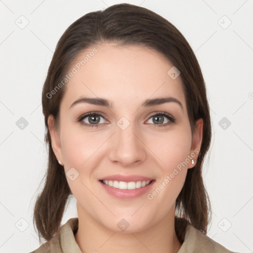 Joyful white young-adult female with long  brown hair and grey eyes