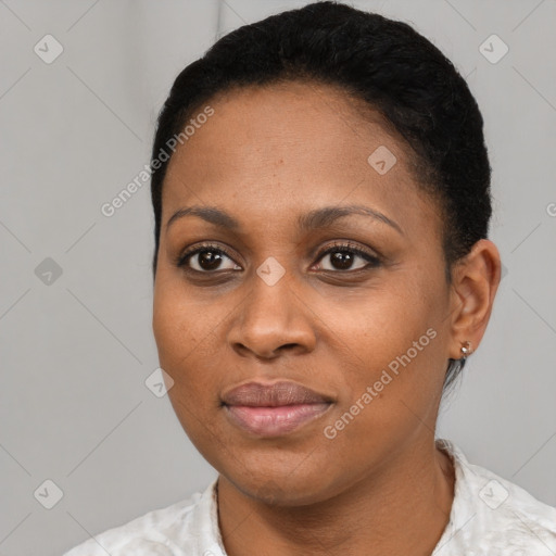 Joyful black young-adult female with short  black hair and brown eyes