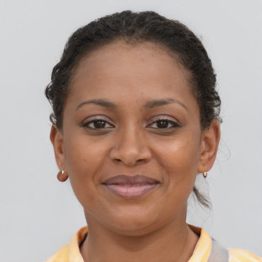 Joyful black young-adult female with short  brown hair and brown eyes