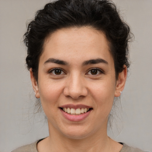 Joyful latino young-adult female with short  brown hair and brown eyes