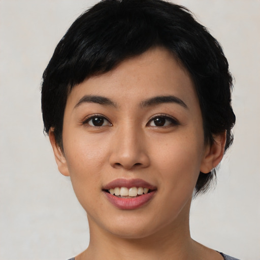 Joyful asian young-adult female with short  black hair and brown eyes