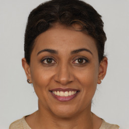 Joyful latino young-adult female with short  brown hair and brown eyes