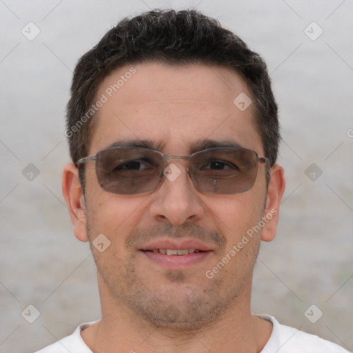 Joyful white adult male with short  brown hair and brown eyes