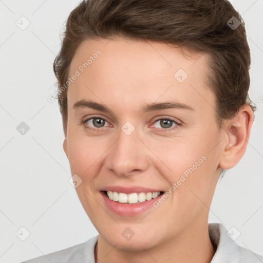 Joyful white young-adult female with short  brown hair and brown eyes