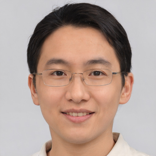 Joyful asian adult male with short  brown hair and brown eyes
