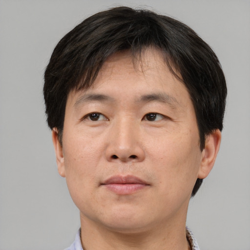 Neutral asian adult male with short  brown hair and brown eyes