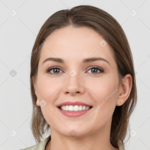 Joyful white young-adult female with medium  brown hair and grey eyes