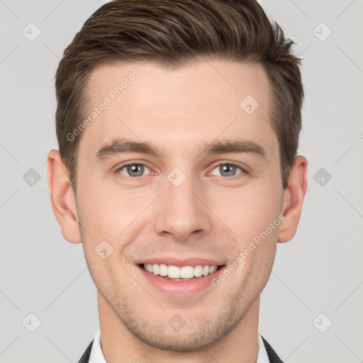 Joyful white young-adult male with short  brown hair and grey eyes