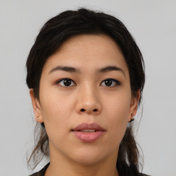 Joyful asian young-adult female with medium  brown hair and brown eyes