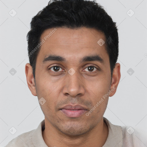 Joyful latino young-adult male with short  black hair and brown eyes