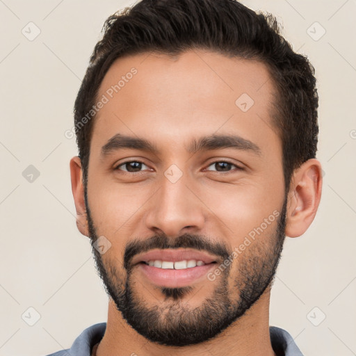 Joyful white young-adult male with short  black hair and brown eyes