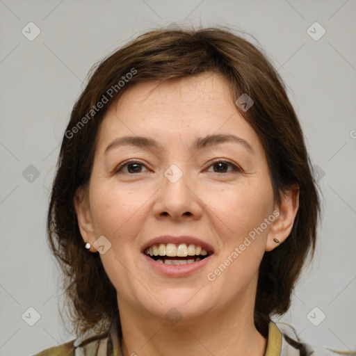 Joyful white adult female with medium  brown hair and brown eyes